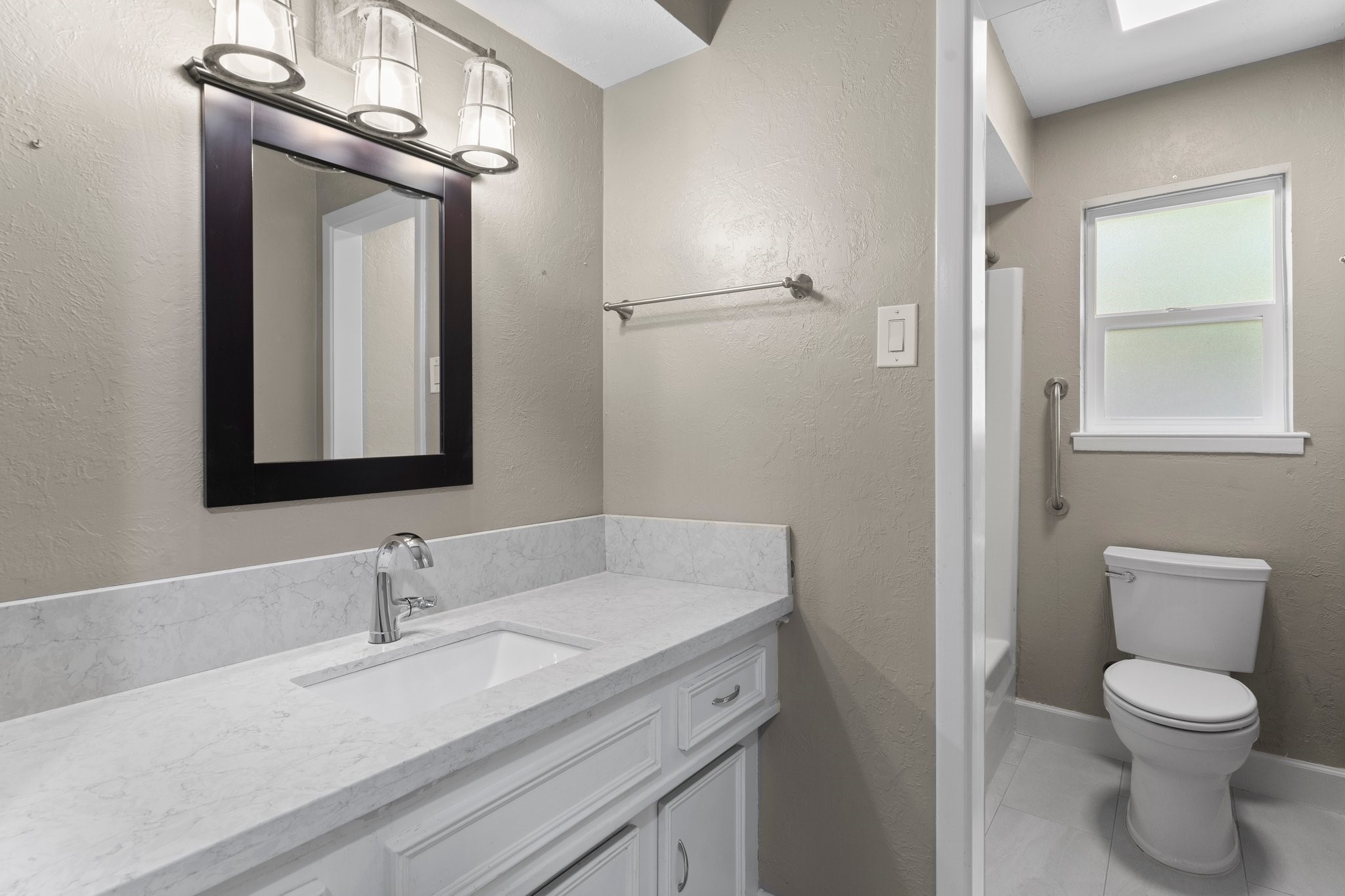 27234 Wells Lane Conroe, TX 77385 - Photo 8 of 15 a bathroom with a granite countertop sink toilet a mirror and shower