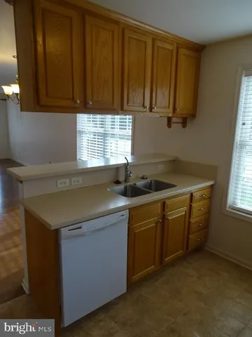 a kitchen with stainless steel appliances granite countertop a refrigerator and a stove