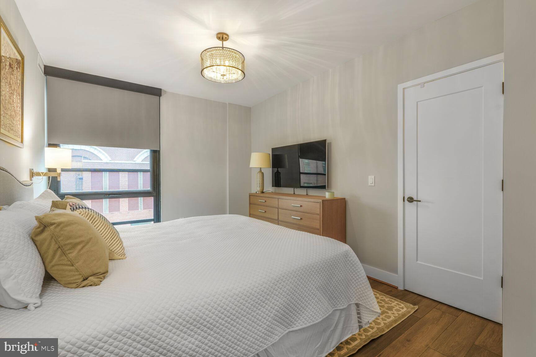 1300 4th Street Southeast, Unit 214 Washington, DC 20003 - Photo 13 of 24 a bedroom with a bed and a tv