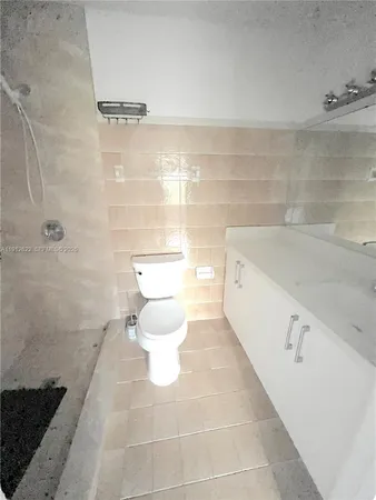 a bathroom with a toilet a sink and shower