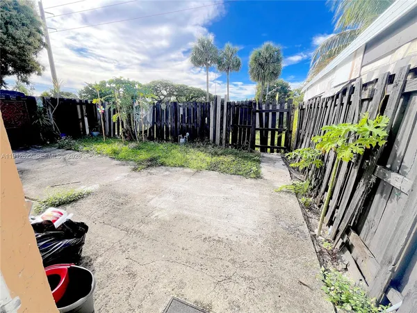 a view of a backyard with sitting area