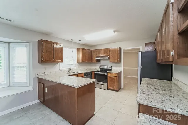 a kitchen with a sink refrigerator and microwave