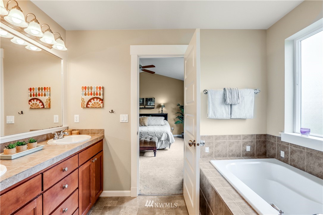 22505 38th Avenue Southeast Bothell, WA 98021 - Photo 18 of 39 a bathroom with a tub sink and mirror