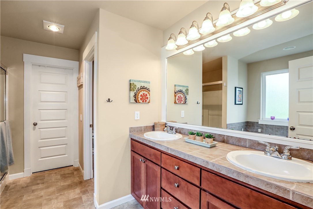 22505 38th Avenue Southeast Bothell, WA 98021 - Photo 19 of 39 a bathroom with a granite countertop sink mirror and vanity