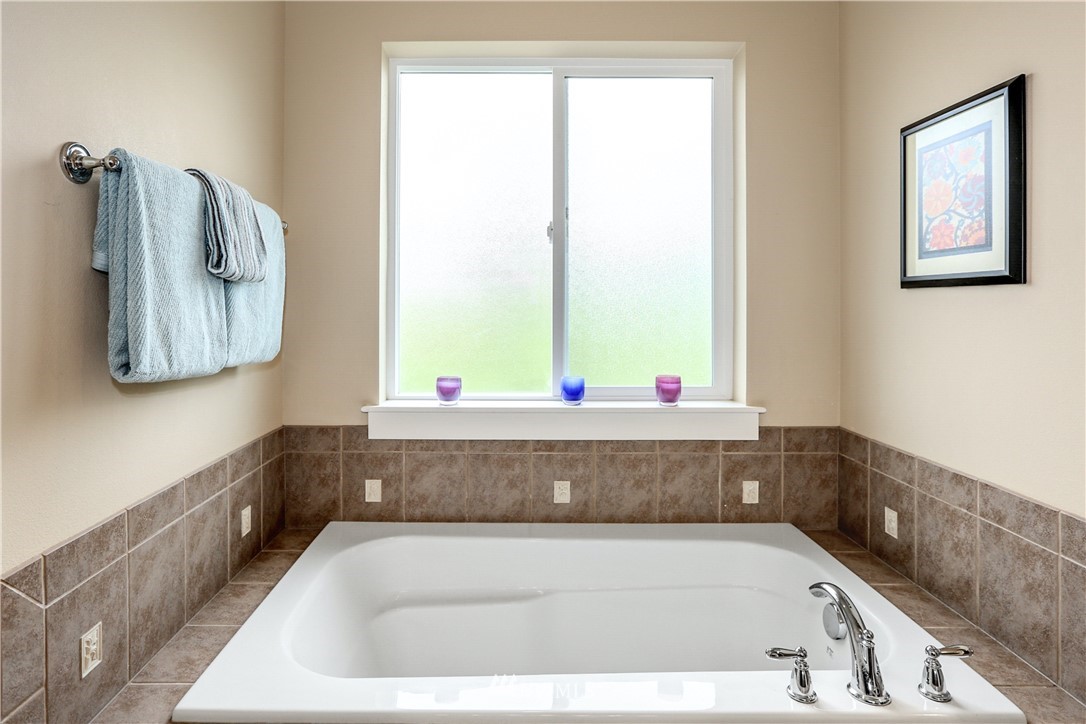 22505 38th Avenue Southeast Bothell, WA 98021 - Photo 20 of 39 a bathroom with a bathtub and window
