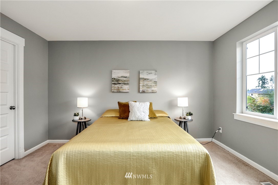 22505 38th Avenue Southeast Bothell, WA 98021 - Photo 22 of 39 a bedroom with a bed and wooden floor