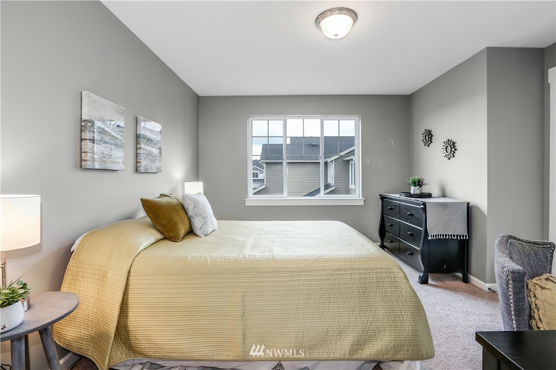 22505 38th Avenue Southeast Bothell, WA 98021 - Photo 23 of 39 a bedroom with a bed and wooden floor