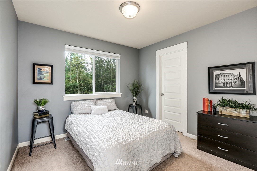 22505 38th Avenue Southeast Bothell, WA 98021 - Photo 24 of 39 a bedroom with a bed and a potted plant
