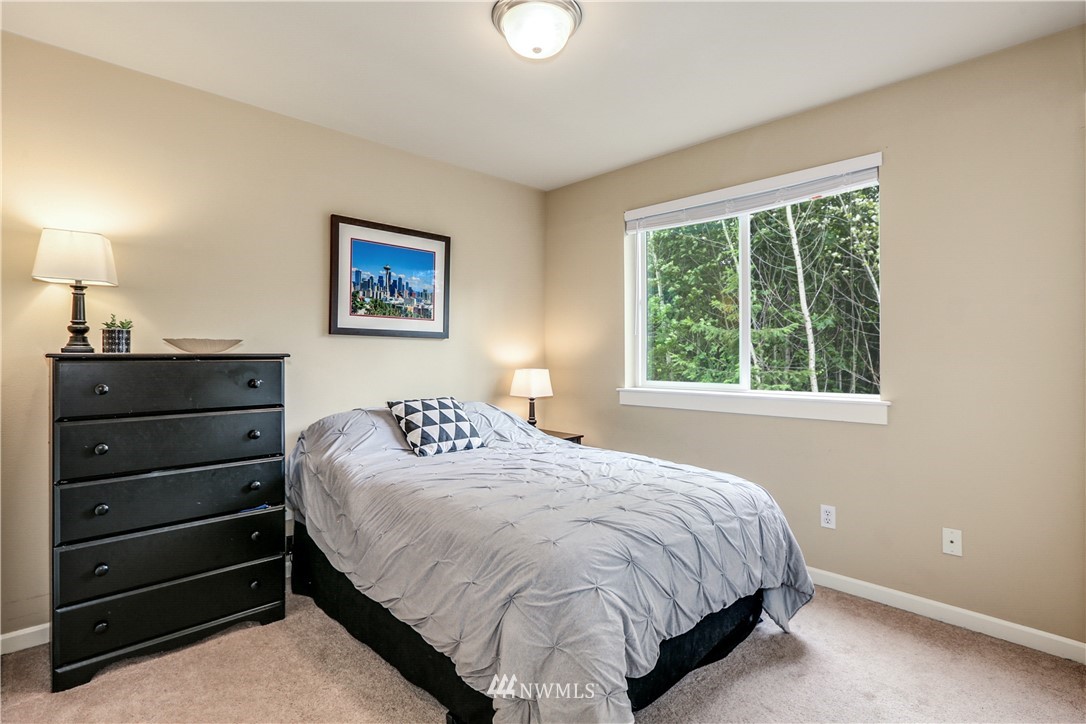 22505 38th Avenue Southeast Bothell, WA 98021 - Photo 26 of 39 a bedroom with a bed and a lamp on dresser