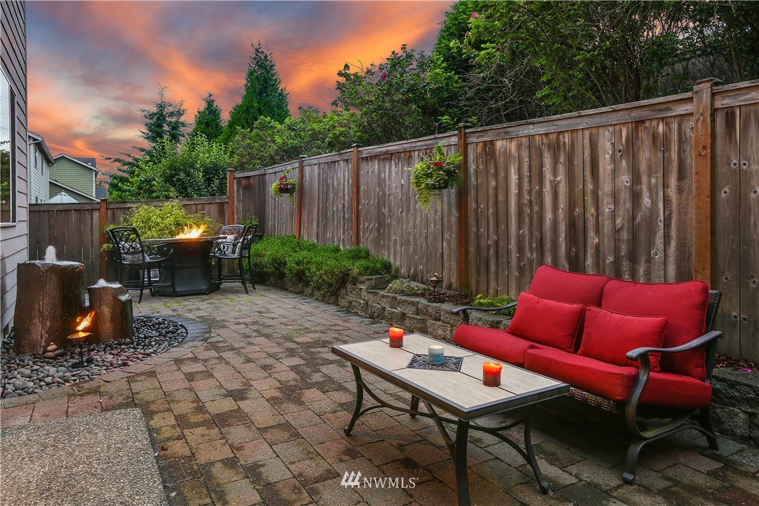22505 38th Avenue Southeast Bothell, WA 98021 - Photo 28 of 39 a backyard of a house with barbeque oven table and chairs