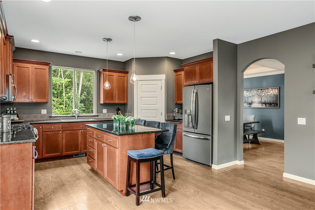 22505 38th Avenue Southeast Bothell, WA 98021 - Photo 9 of 39 a kitchen with stainless steel appliances granite countertop a refrigerator and a stove top oven