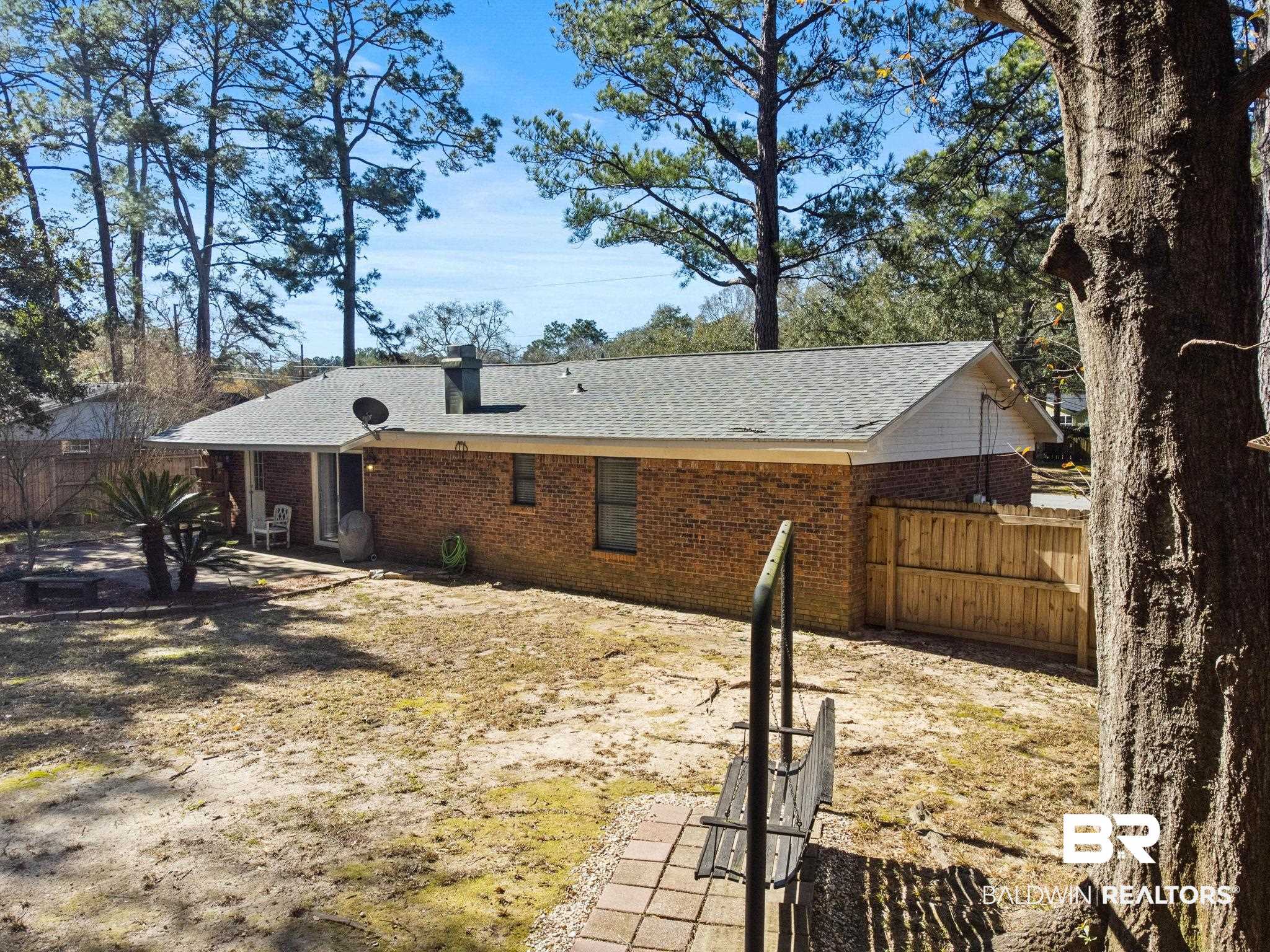 5366 Scanlan Way West Satsuma, AL 36572 - Photo 33 of 43 Rear view of property with a fenced backyard, a shingled roof, brick siding, and a chimney