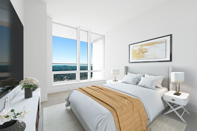 a bedroom with a large bed and a window