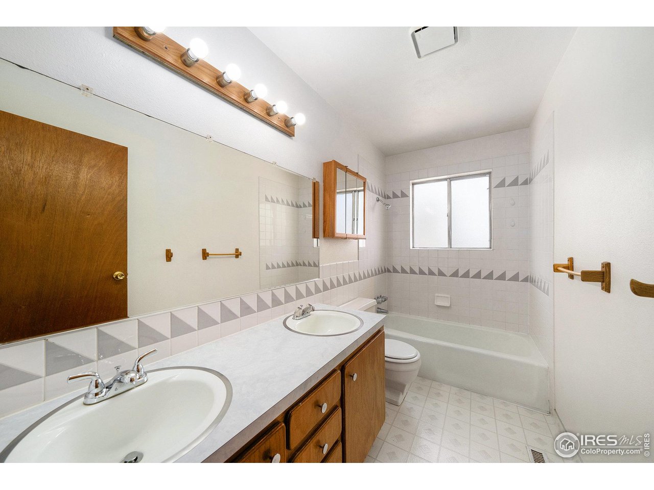 3237 West 5th St Road Greeley, CO 80634 - Photo 11 of 23 a bathroom with a granite countertop sink a mirror a bathtub and shower