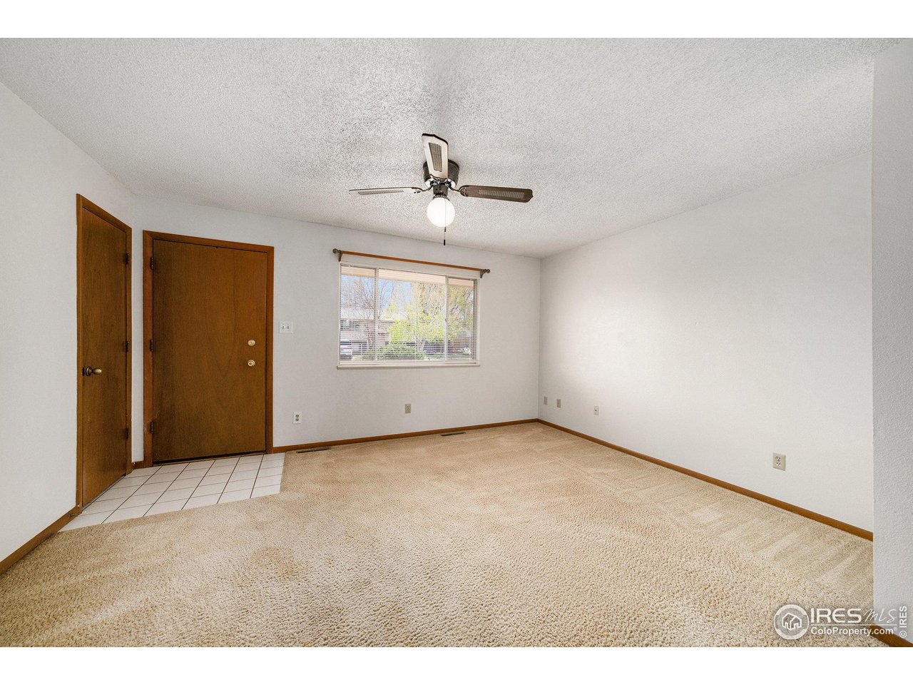 3237 West 5th St Road Greeley, CO 80634 - Photo 4 of 23 an empty room with windows and ceiling fan