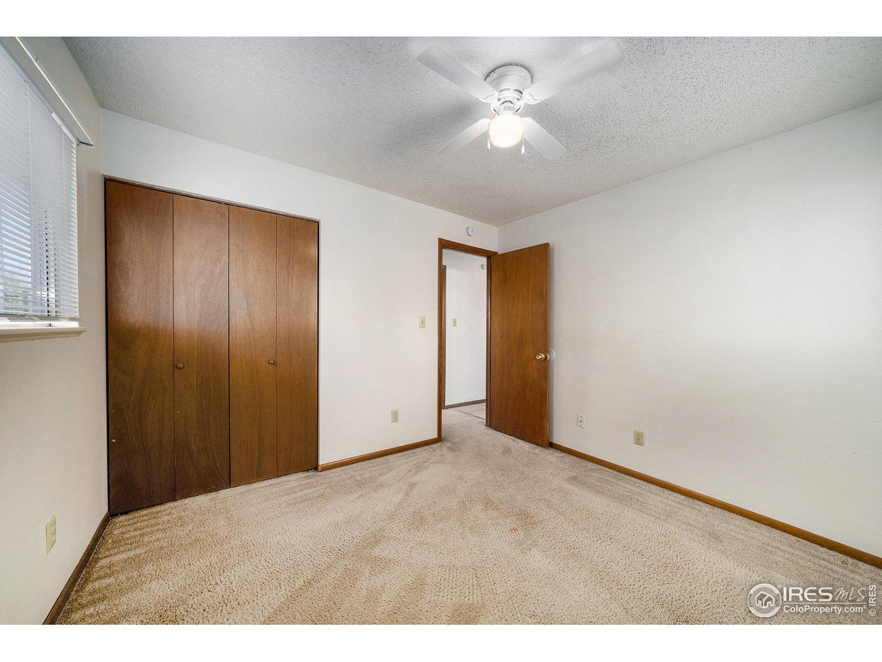 3237 West 5th St Road Greeley, CO 80634 - Photo 10 of 23 a view of an empty room with a chandelier