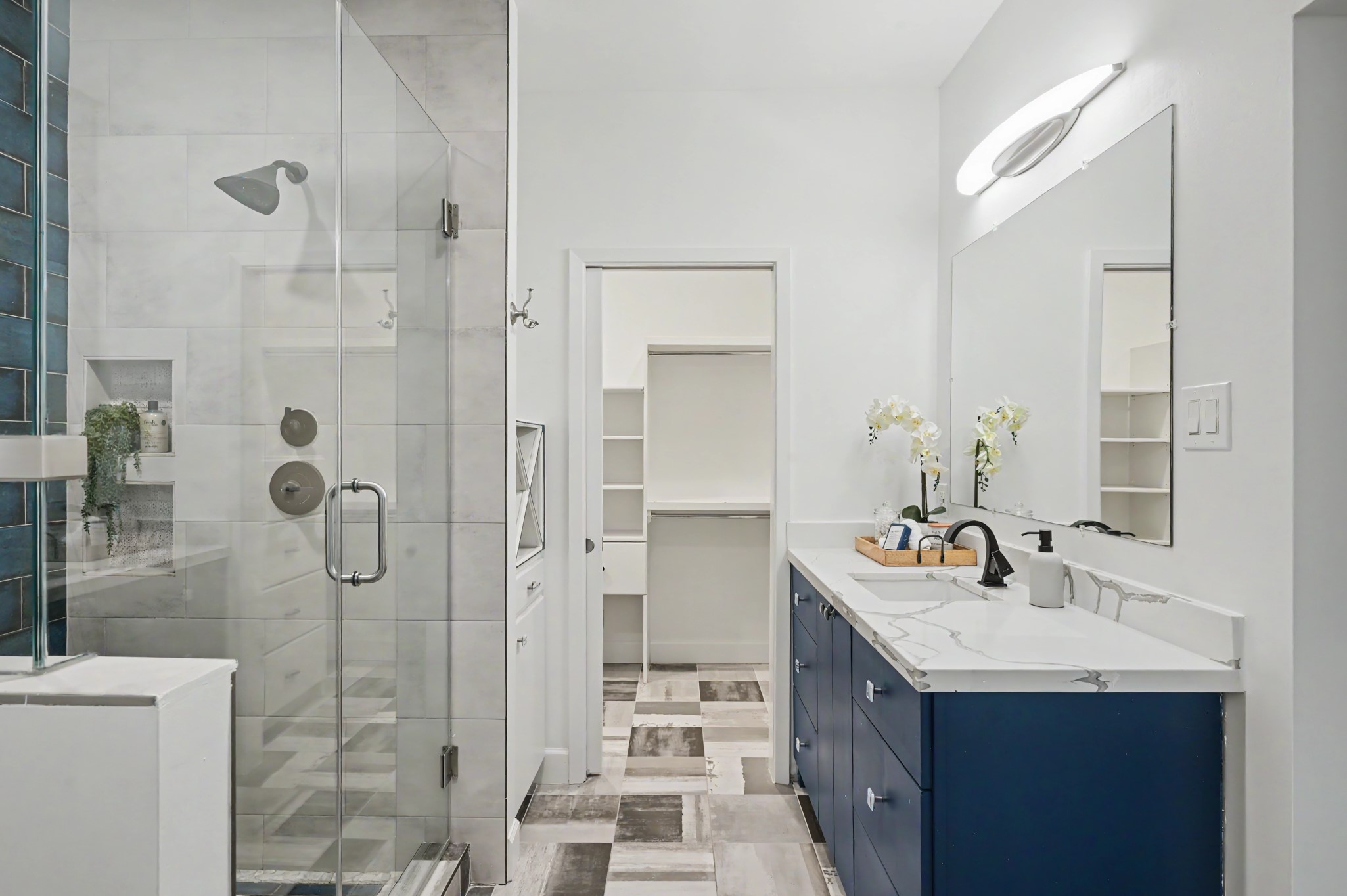 807 Key Street Houston, TX 77009 - Photo 17 of 27 Updated primary bath with a glass-enclosed walk-in shower, quartz-topped vanity, and direct access to the walk-in closet.