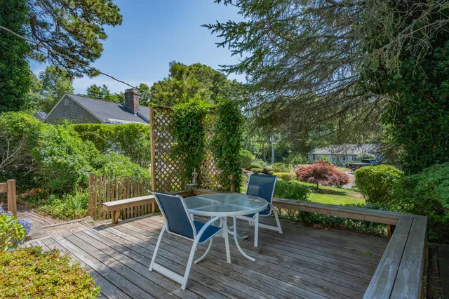 a view of backyard with seating space and trees