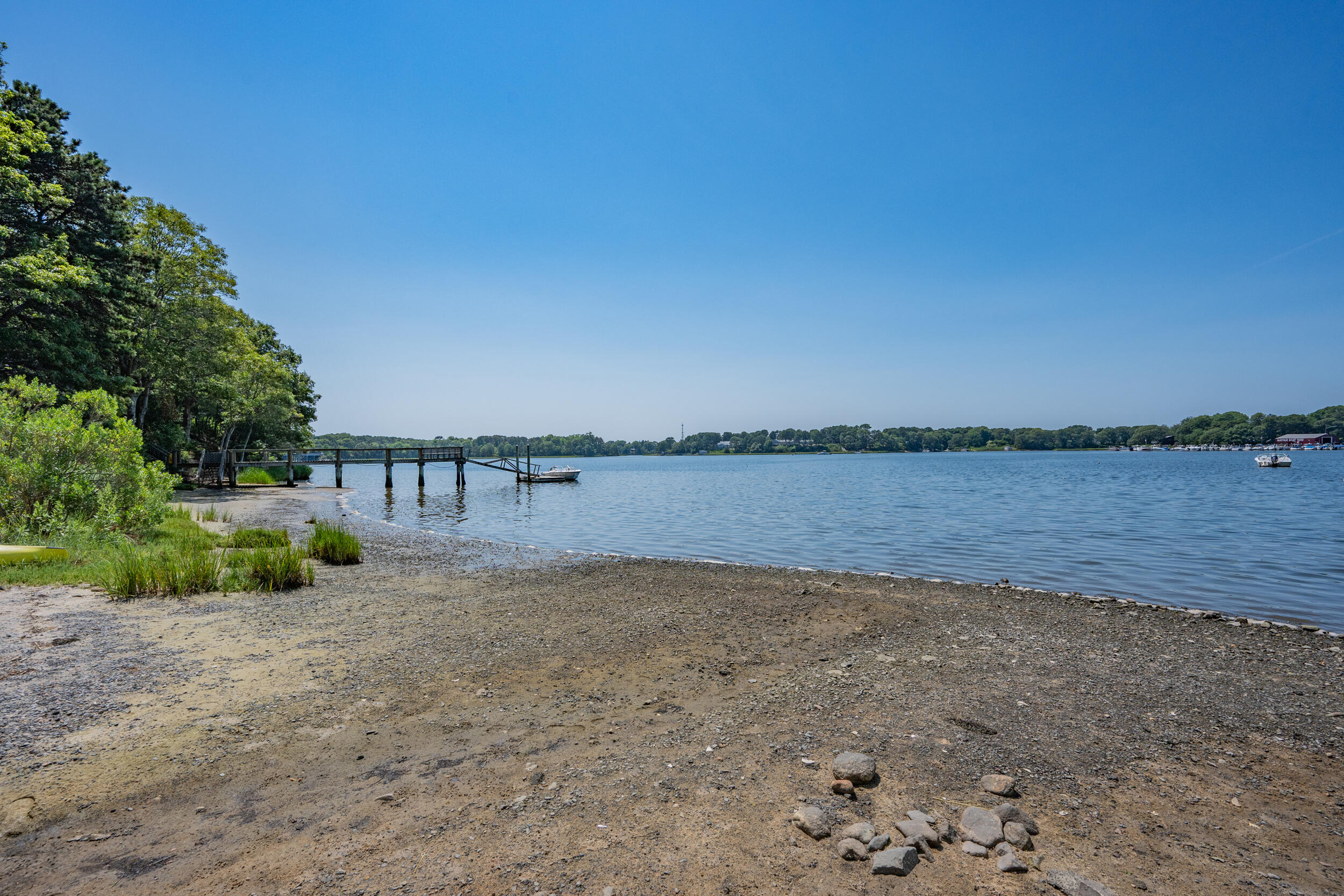 62 Old Fish House Road South Dennis, MA 02660 - Photo 23 of 24 a view of a lake with a building in the background