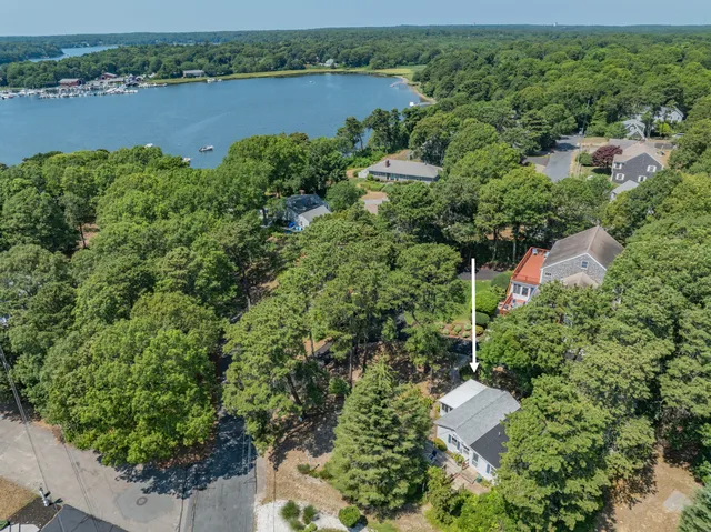 an aerial view of a house with outdoor space and lake view