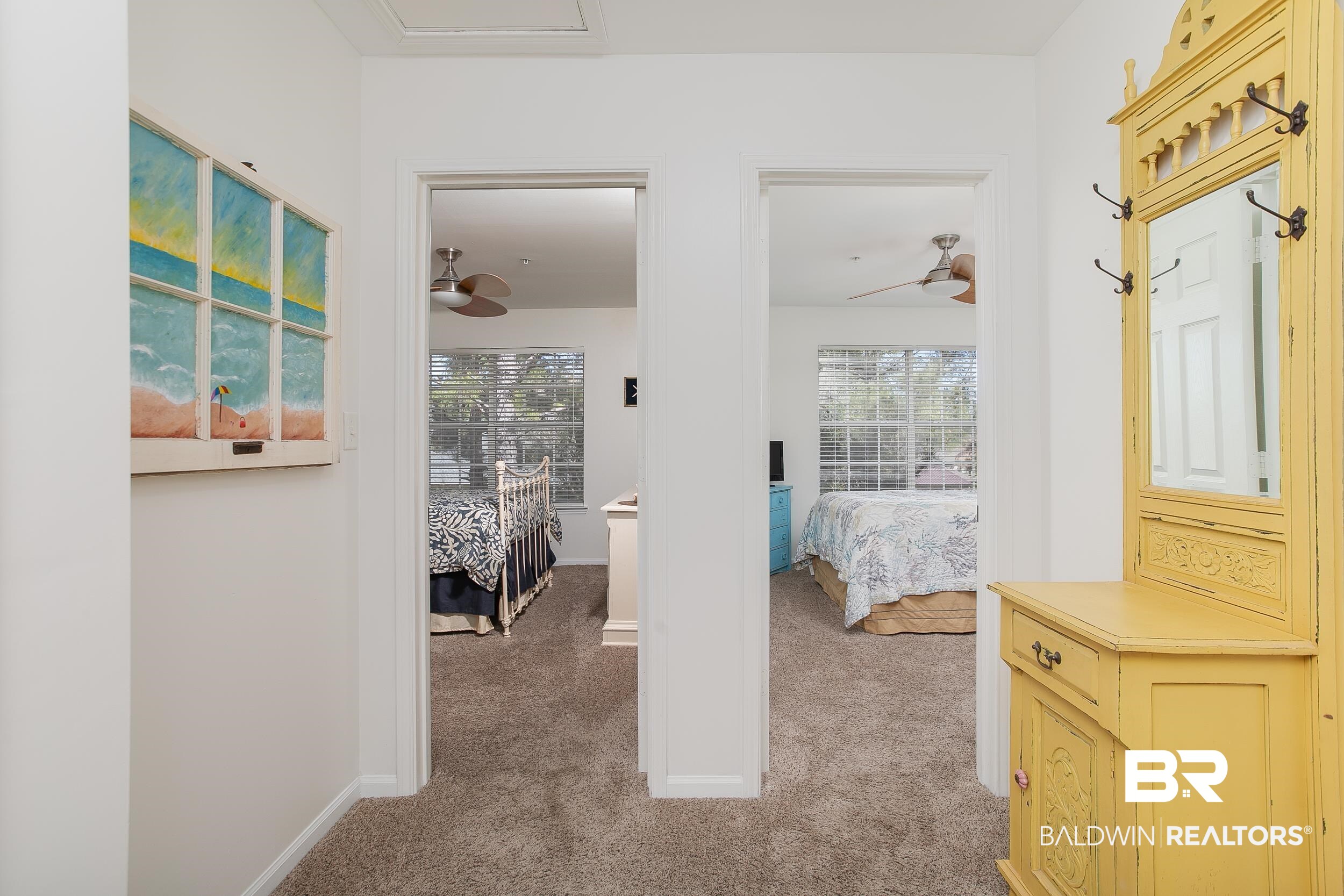1517 Regency Road, Unit 33 Gulf Shores, AL 36542 - Photo 23 of 29 Corridor with light carpet, a healthy amount of sunlight, and baseboards
