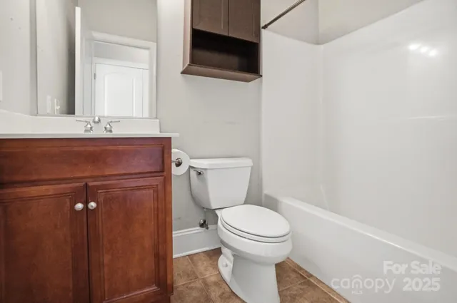 a bathroom with a toilet a sink and a mirror