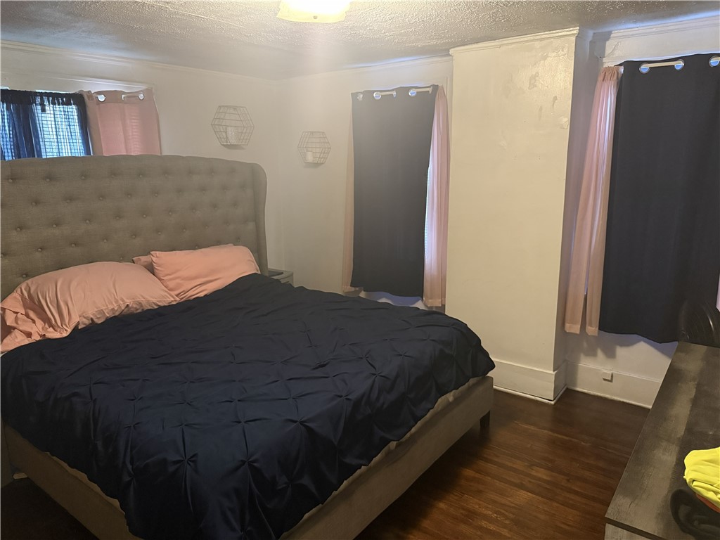 417 South Seigel Street Decatur, IL 62522 - Photo 9 of 11 a bedroom with a bed and a refrigerator