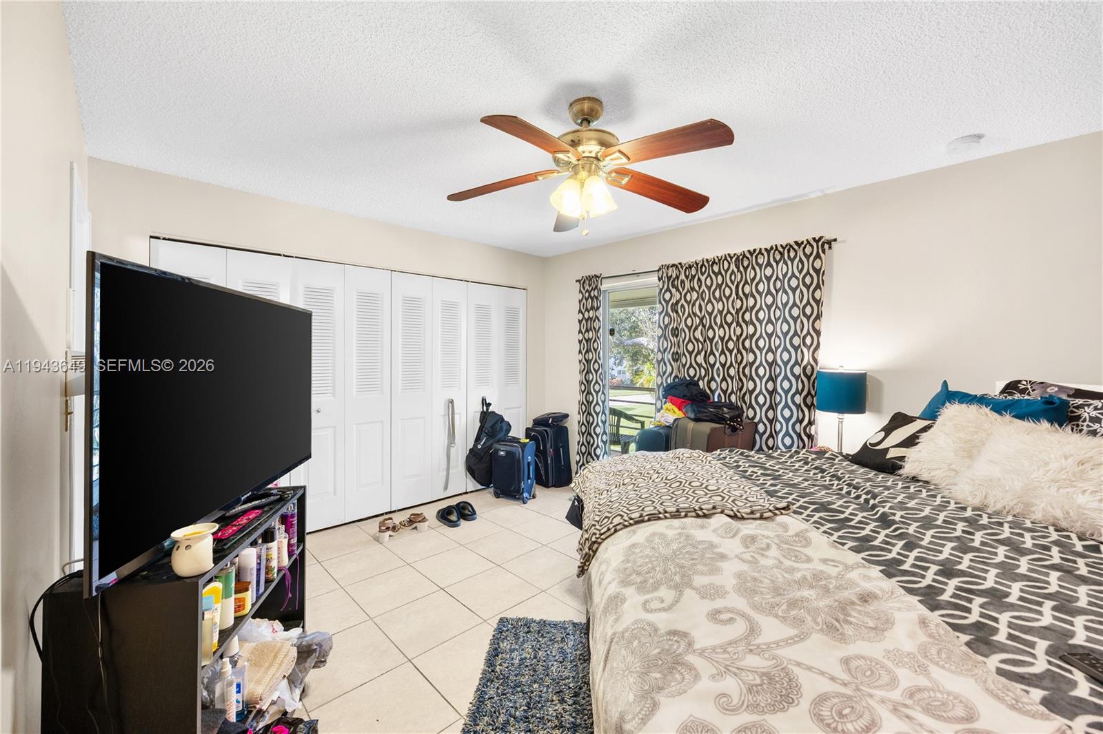 446 Durham O, Unit 446 Deerfield Beach, FL 33442 - Photo 15 of 26 a bedroom with a bed and a flat screen tv