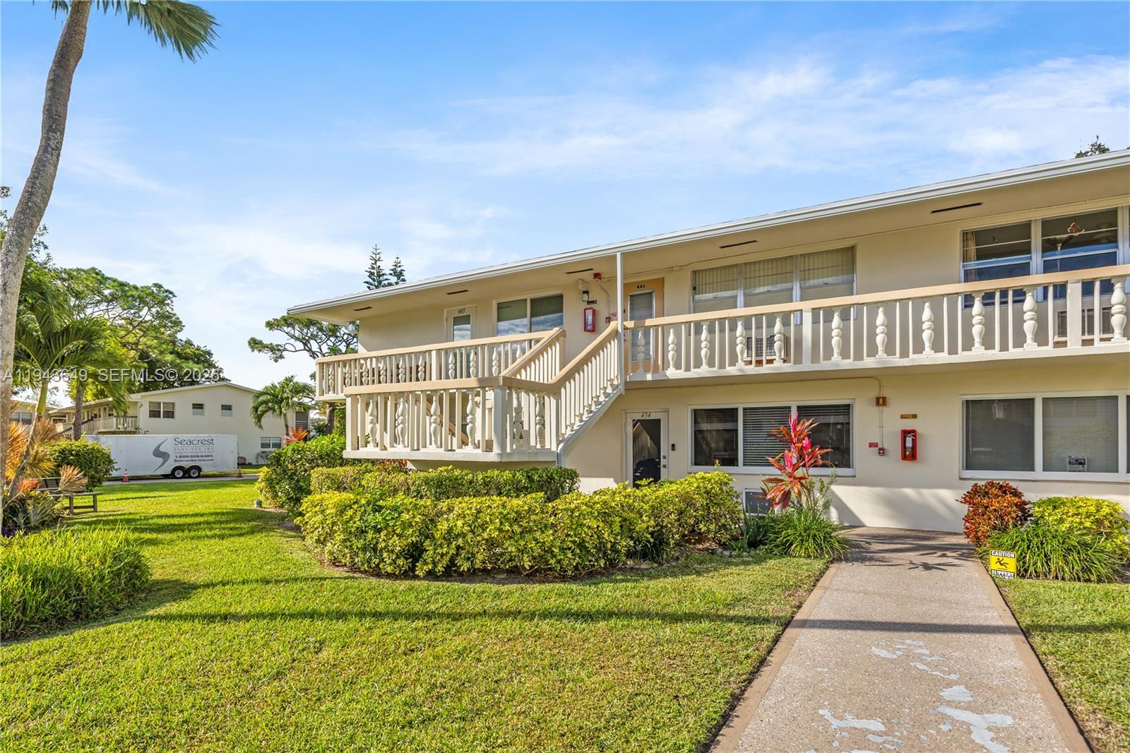 446 Durham O, Unit 446 Deerfield Beach, FL 33442 - Photo 22 of 26 front view of a house with a yard