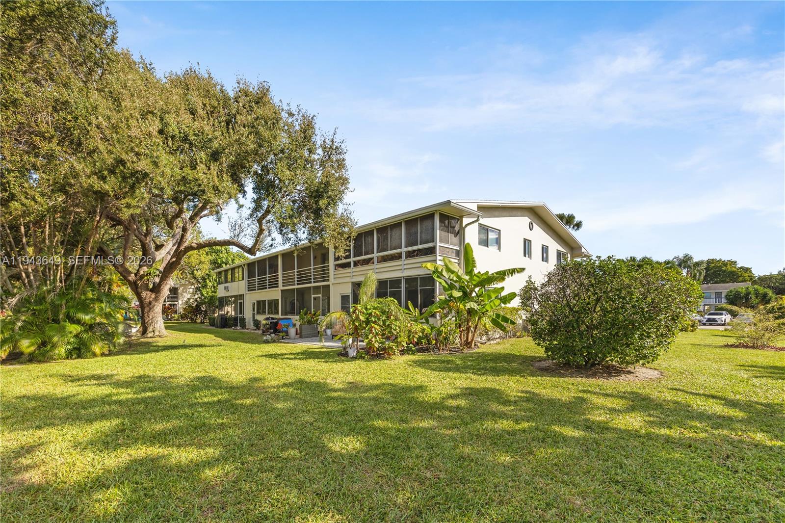 446 Durham O, Unit 446 Deerfield Beach, FL 33442 - Photo 25 of 26 a large building with trees in the background