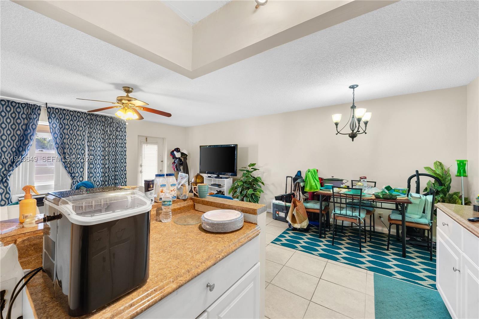 446 Durham O, Unit 446 Deerfield Beach, FL 33442 - Photo 8 of 26 a kitchen with sink refrigerator dining table and chairs