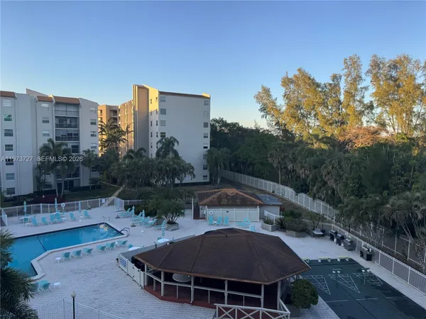 a view of a patio with table and chairs and potted plants
