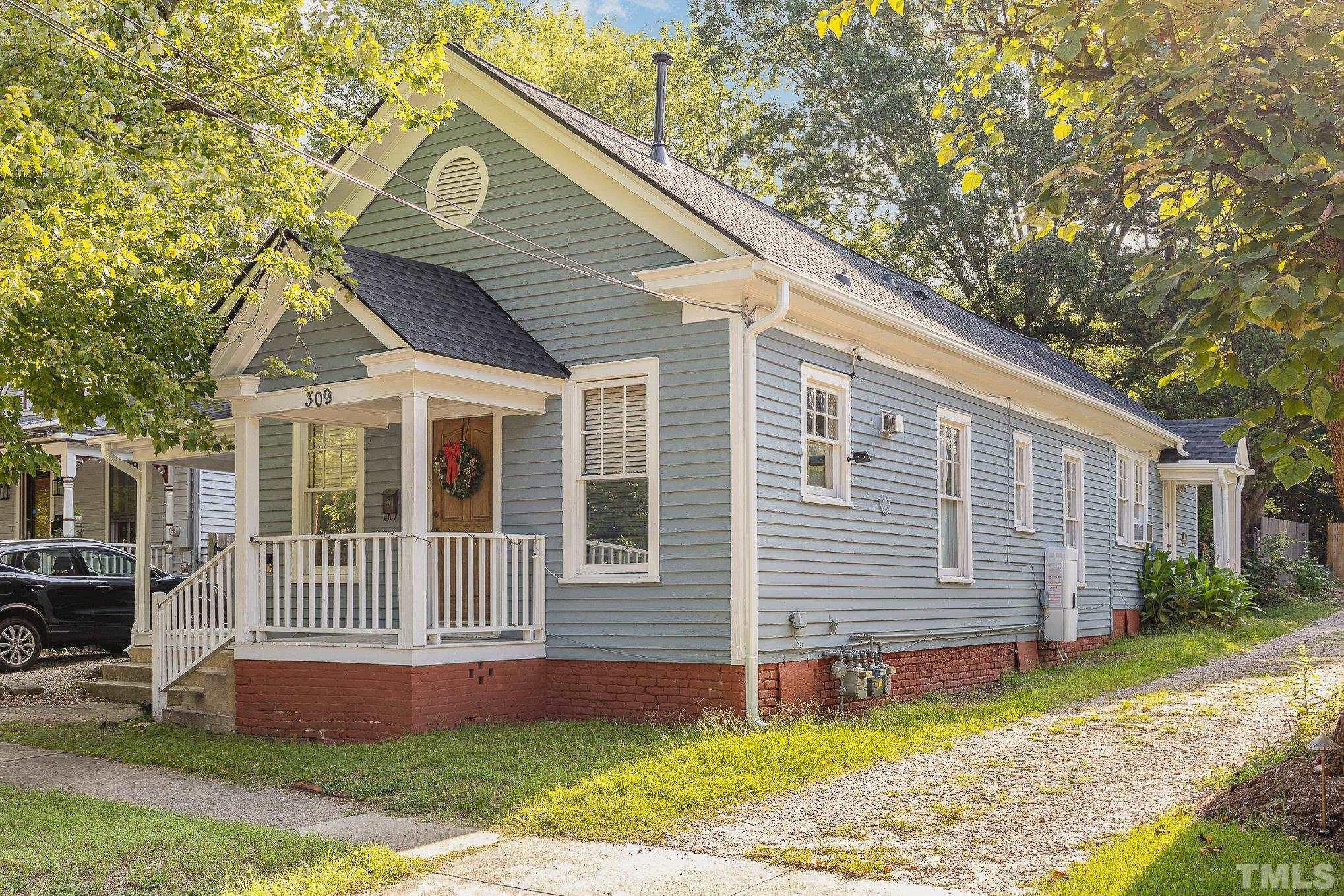 309 Cutler Street, Unit 3 Raleigh, NC 27603 - Photo 1 of 17 a front view of a house with a yard