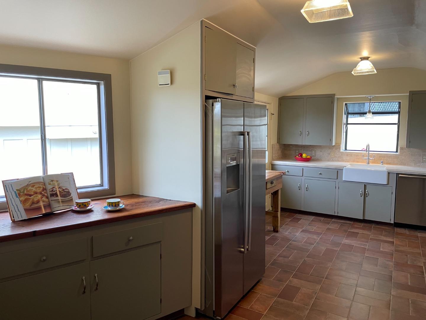 529 Monterey Drive Aptos, CA 95003 - Photo 14 of 32 a kitchen with stainless steel appliances kitchen island granite countertop a refrigerator and a sink
