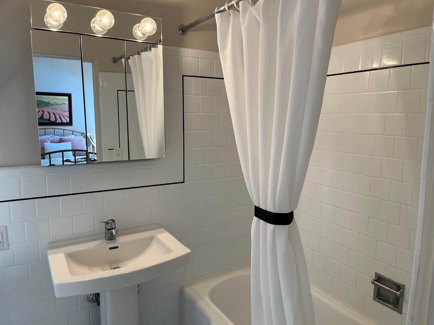 529 Monterey Drive Aptos, CA 95003 - Photo 20 of 32 a bathroom with a sink a mirror and a shower