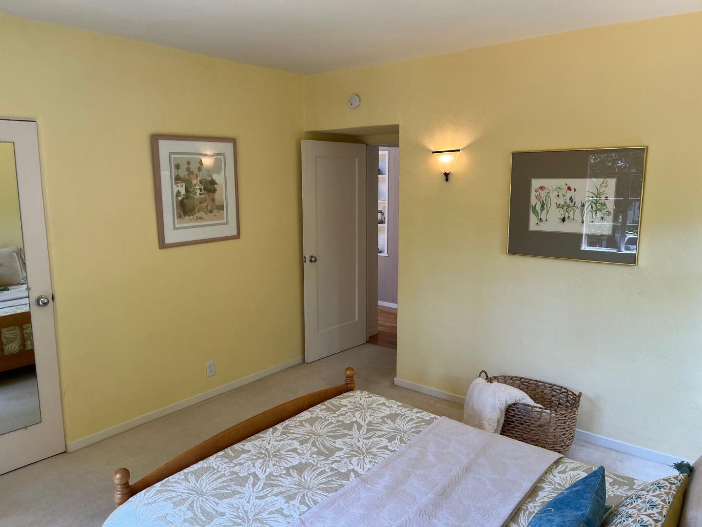 529 Monterey Drive Aptos, CA 95003 - Photo 23 of 32 a bedroom with a bed and wooden floor