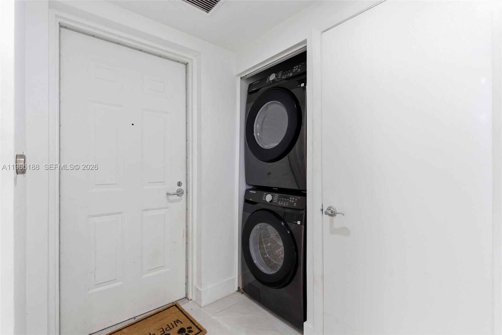 7290 Southwest 90th Street, Unit 209 Miami, FL 33156 - Photo 11 of 40 a view of a hallway with washer and dryer