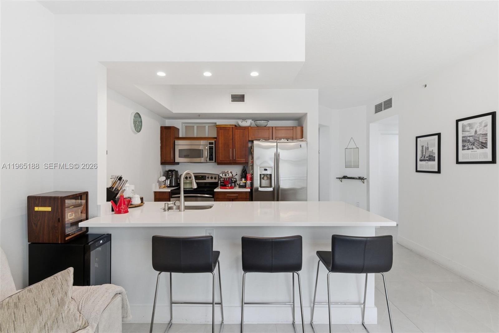 7290 Southwest 90th Street, Unit 209 Miami, FL 33156 - Photo 17 of 40 a kitchen with stainless steel appliances a sink and a refrigerator