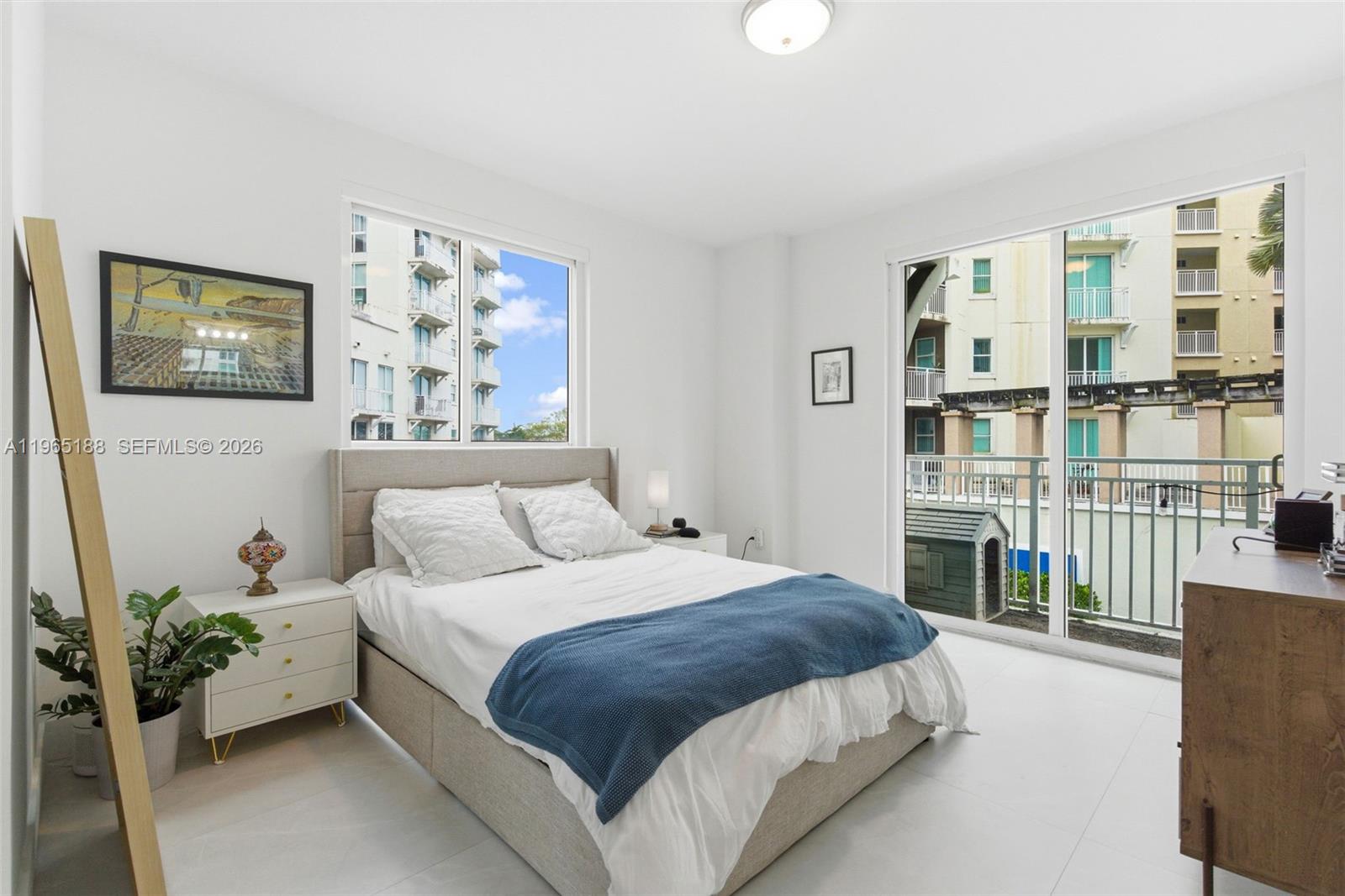 7290 Southwest 90th Street, Unit 209 Miami, FL 33156 - Photo 23 of 40 a bedroom with a large bed and a couch
