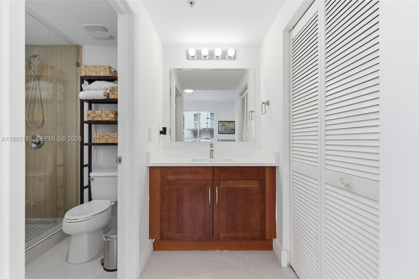 7290 Southwest 90th Street, Unit 209 Miami, FL 33156 - Photo 26 of 40 a bathroom with a sink a toilet and shower