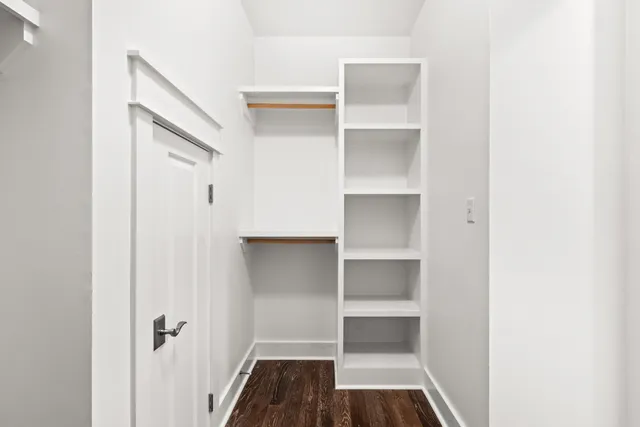 a view of walk in closet with empty racks