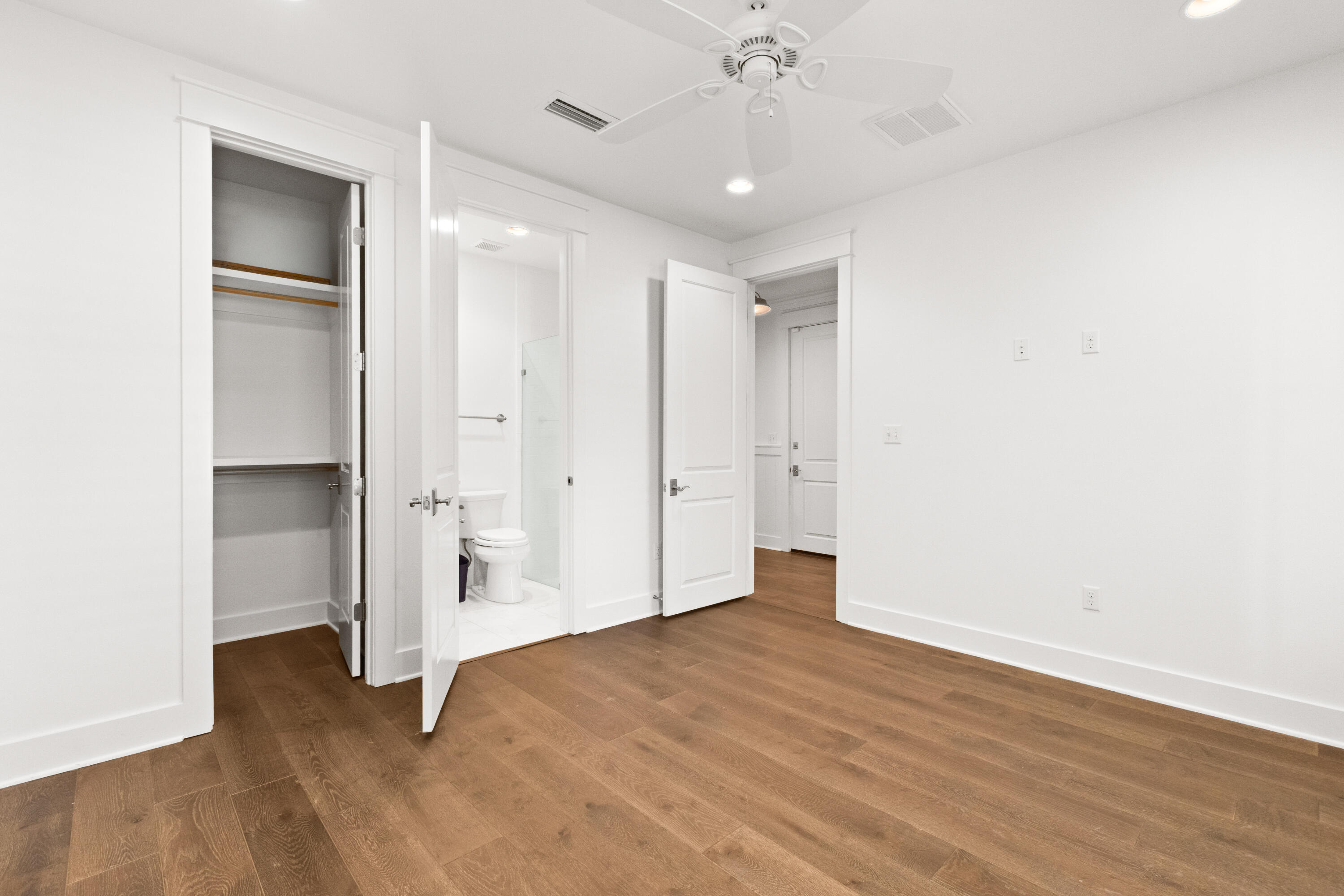 309 Jack Knife Drive Inlet Beach, FL 32461 - Photo 18 of 43 an empty room with wooden floor and ceiling fan