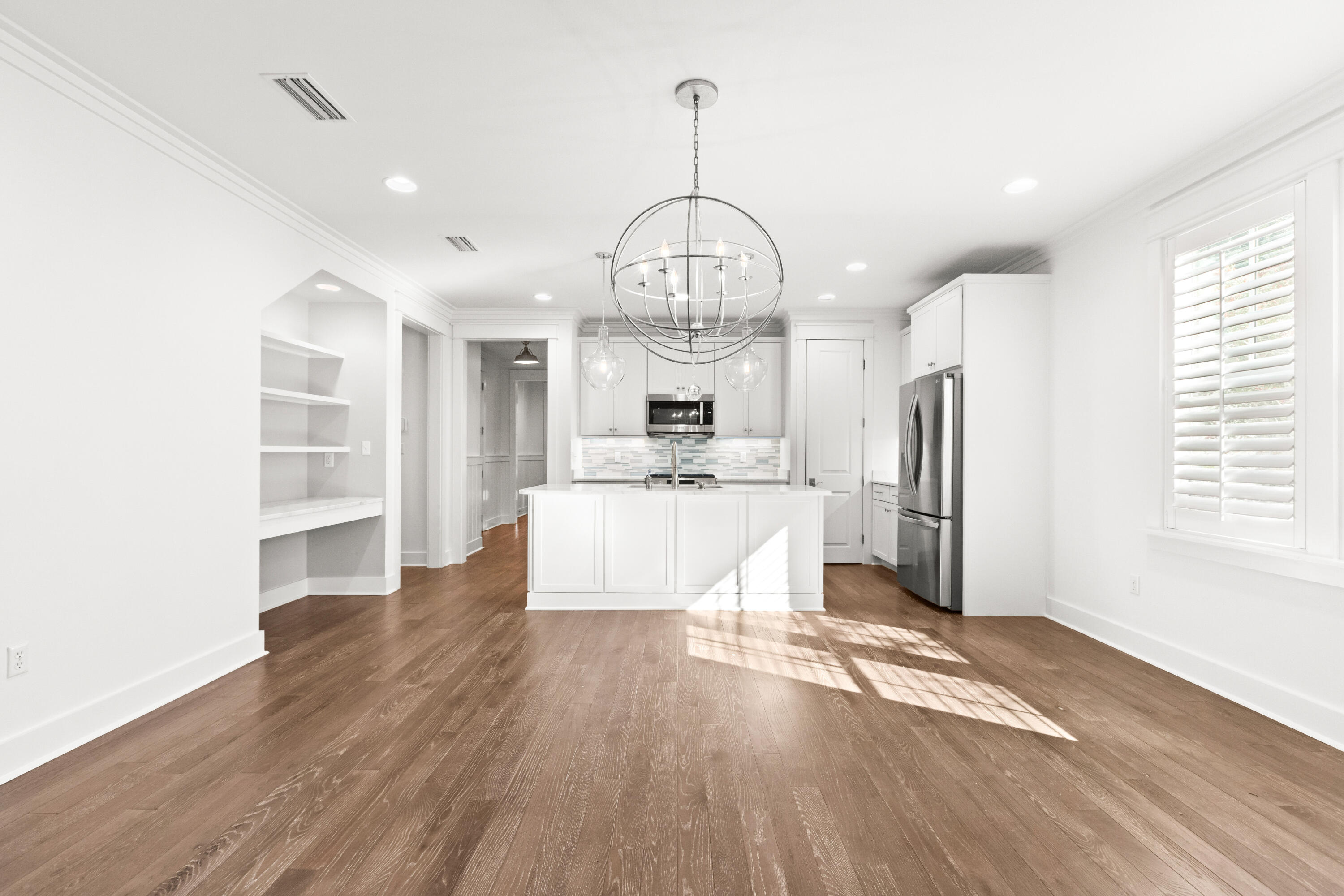 309 Jack Knife Drive Inlet Beach, FL 32461 - Photo 8 of 43 a large room with wooden floor a kitchen and windows