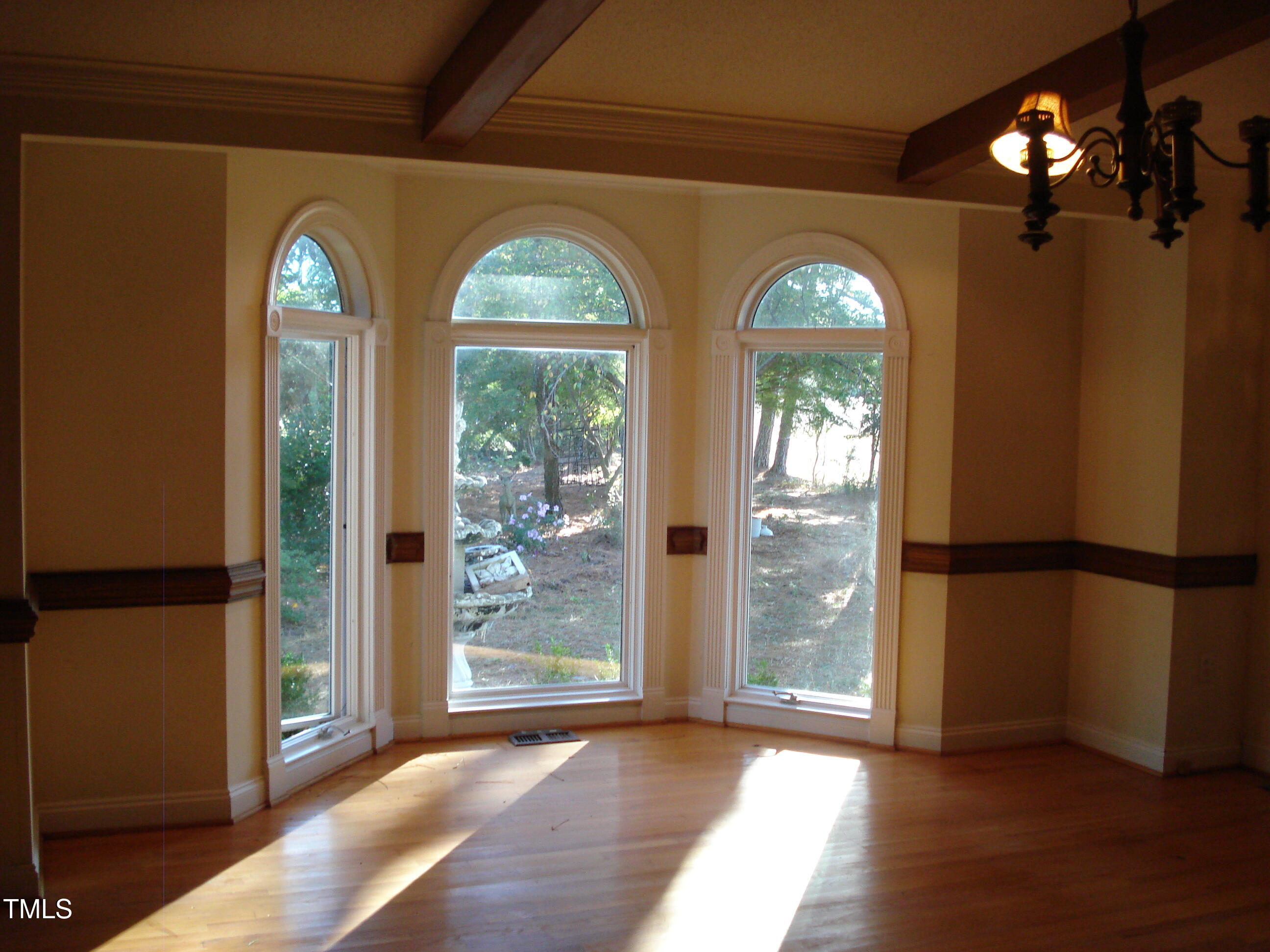 6349 Elevation Road Benson, NC 27504 - Photo 21 of 66 a view of empty room with windows wooden floor and outdoor view