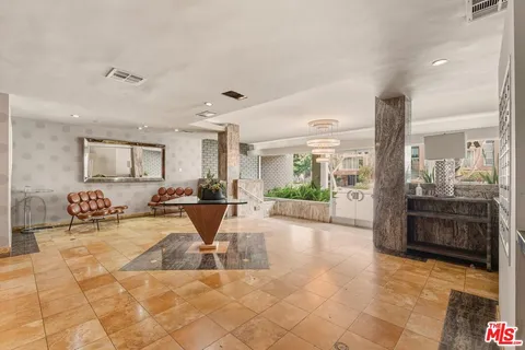 a view of a lobby with furniture and floor to ceiling window