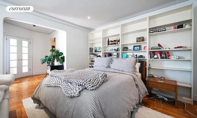 a bed room with a bed and a book shelf