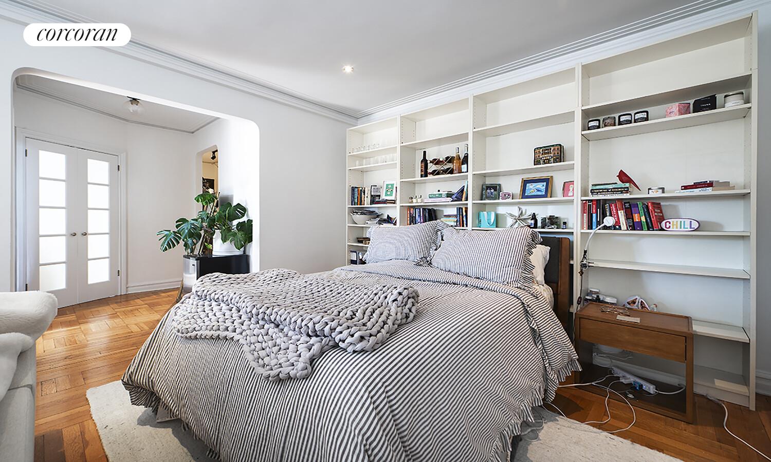 255 West 23rd Street, Unit 5FW Manhattan, NY 10011 - Photo 3 of 8 a bed room with a bed and a book shelf