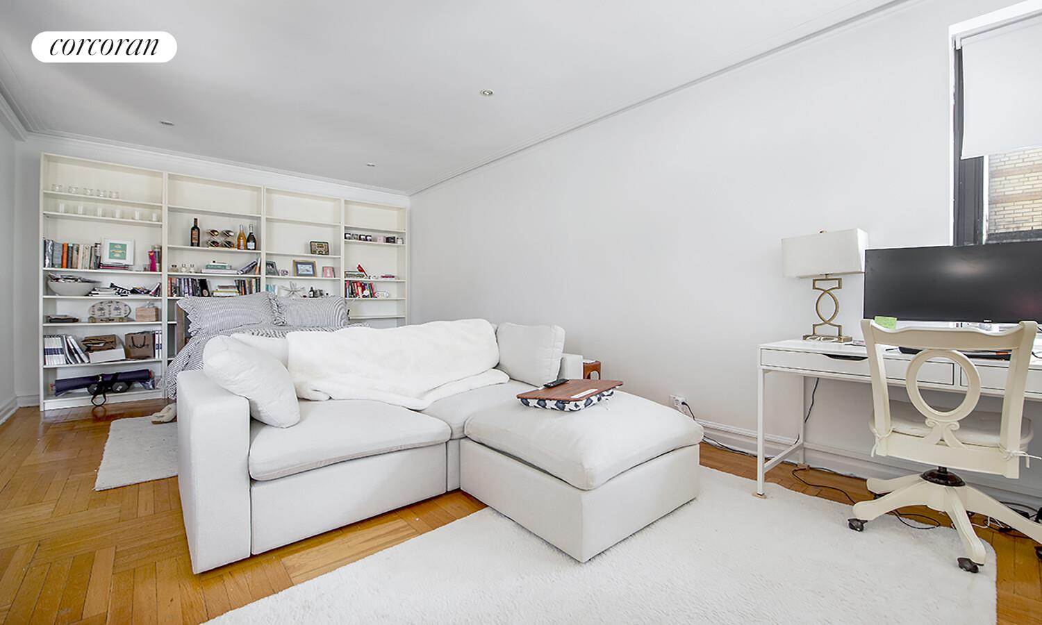 255 West 23rd Street, Unit 5FW Manhattan, NY 10011 - Photo 4 of 8 a living room with furniture and a flat screen tv