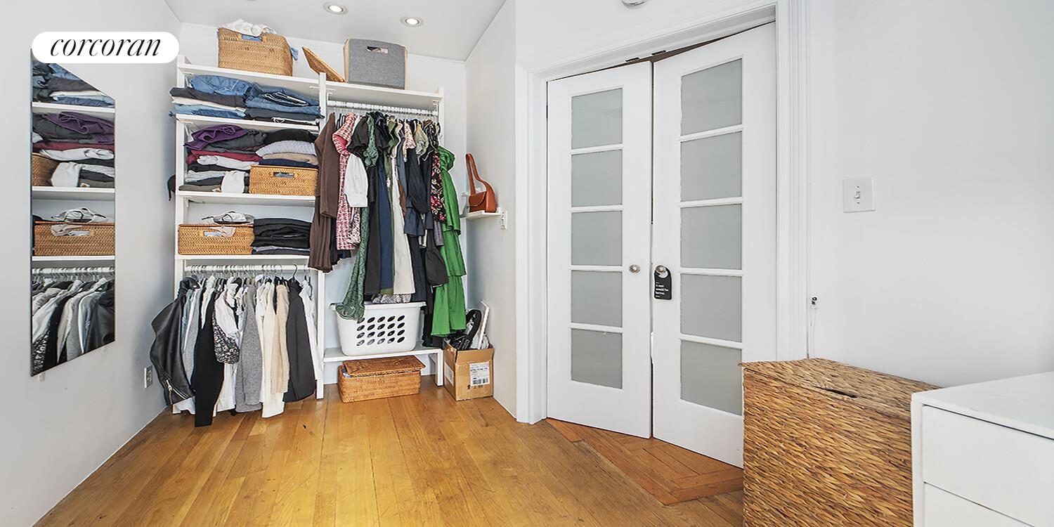 255 West 23rd Street, Unit 5FW Manhattan, NY 10011 - Photo 5 of 8 a view of walk in closet with clothes and shoes