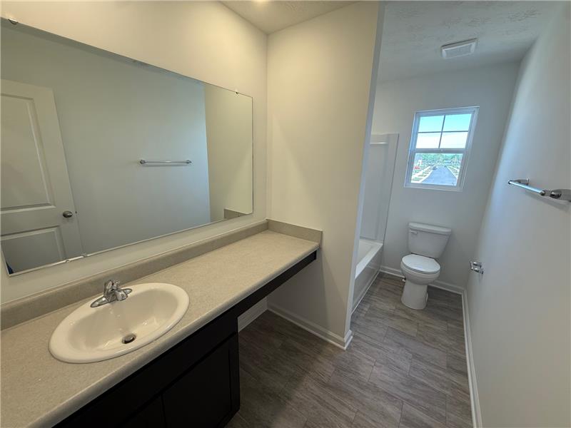 4005 Chakeres Avenue Springfield, OH 45505 - Photo 16 of 19 This bathroom features a contemporary vanity and an inviting bath, creating a refreshing daily retreat.